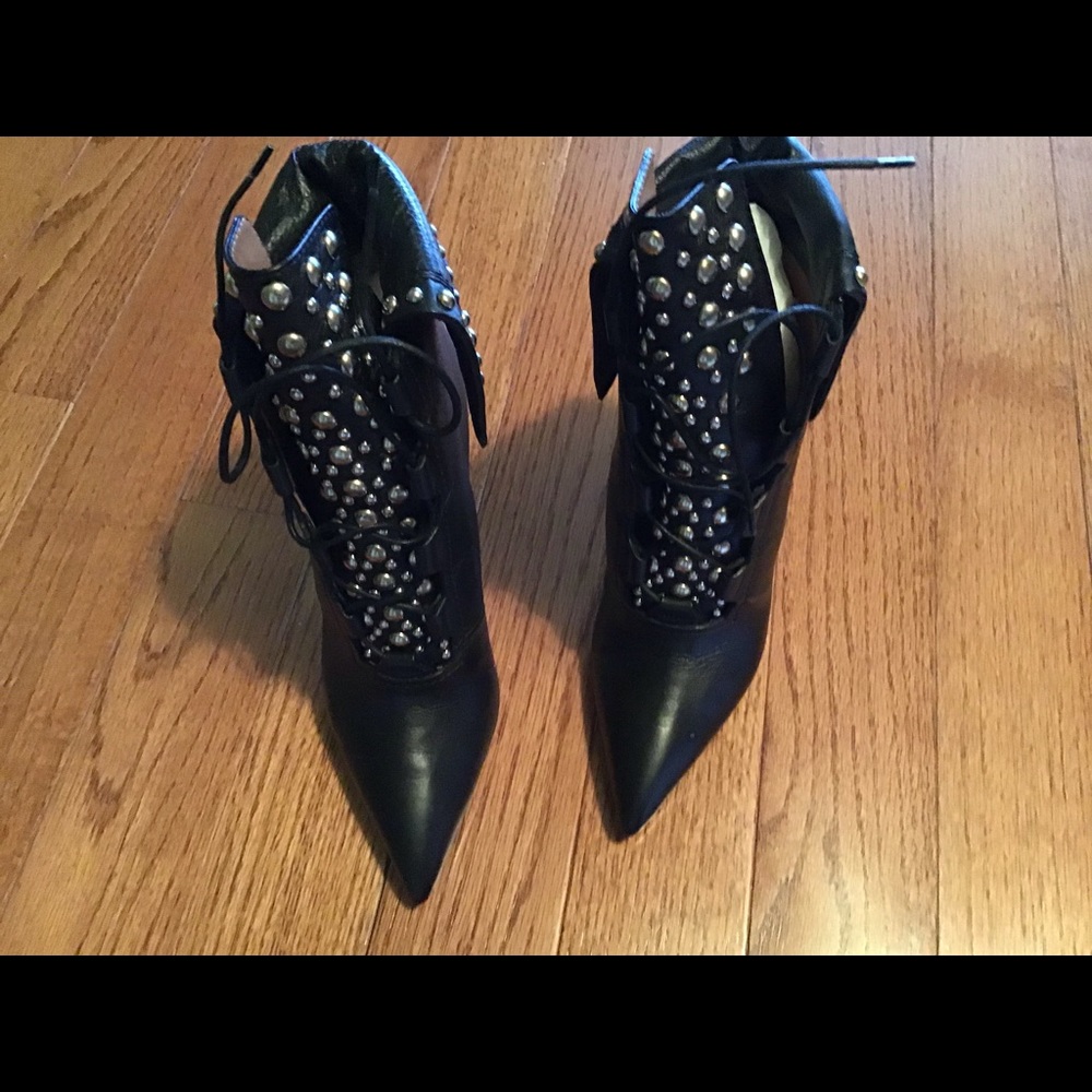 Givenchy leather booties  metal embellishments.